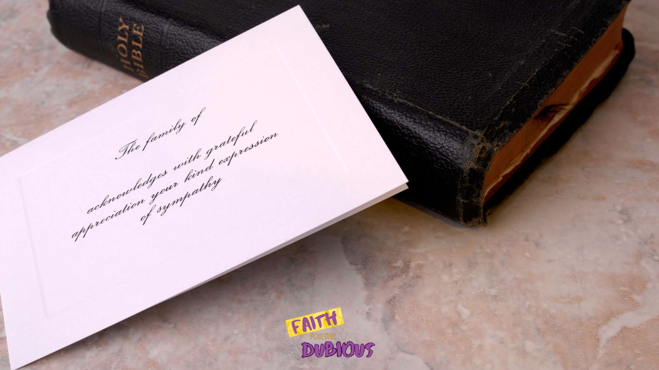 A funeral announcement next to a bible indicating that bible verses for sympathy cards can provide needed comfort.