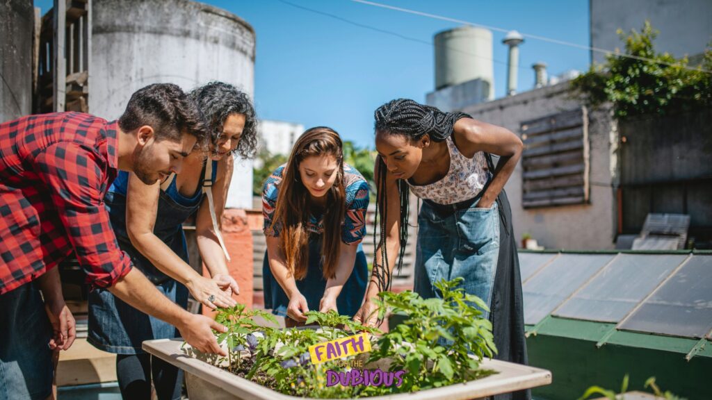 Volunteers tending a raised garden bed.
